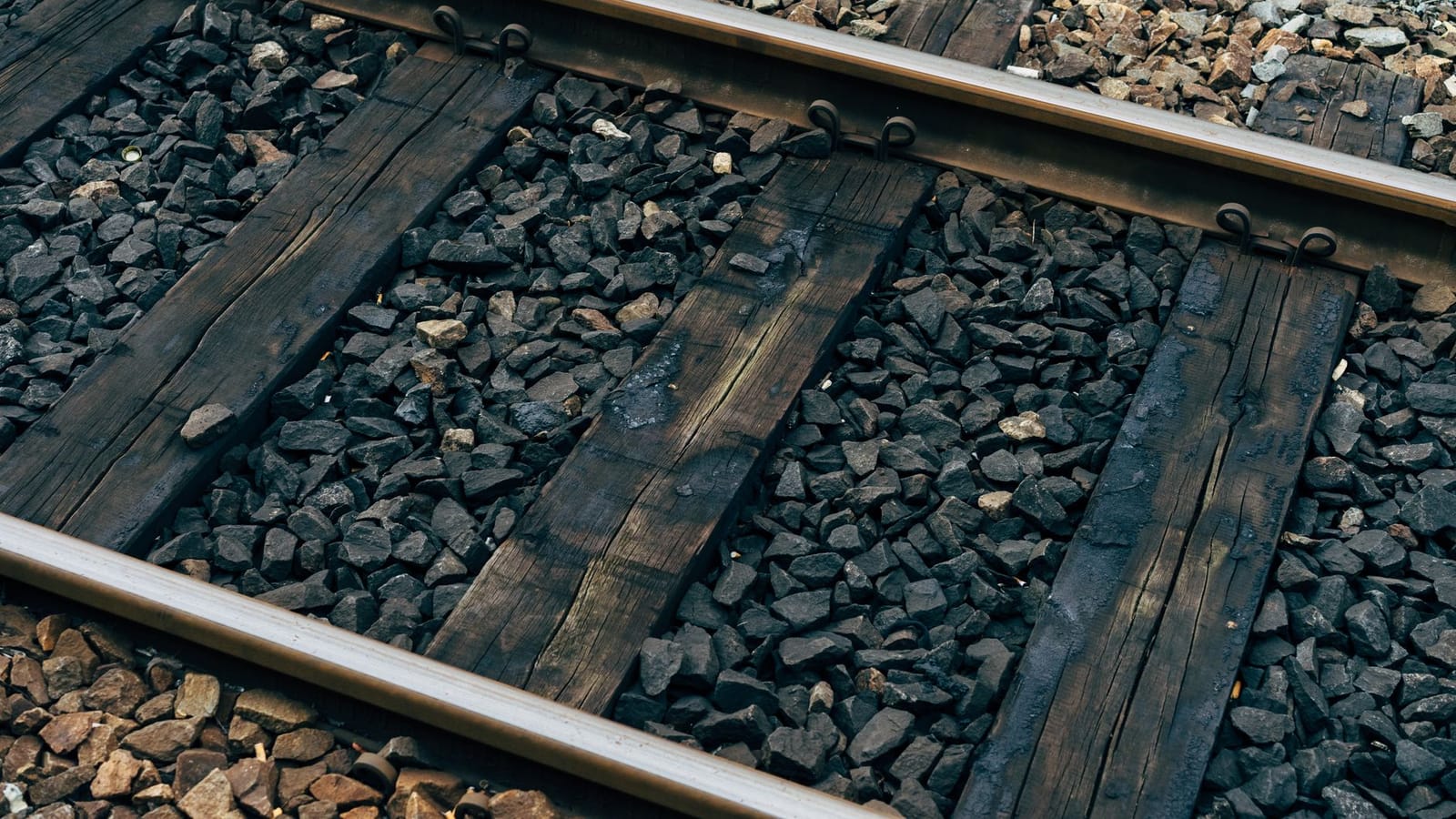 Detailed view of railroad tracks with wooden sleepers and gravel in Hechingen, Germany.