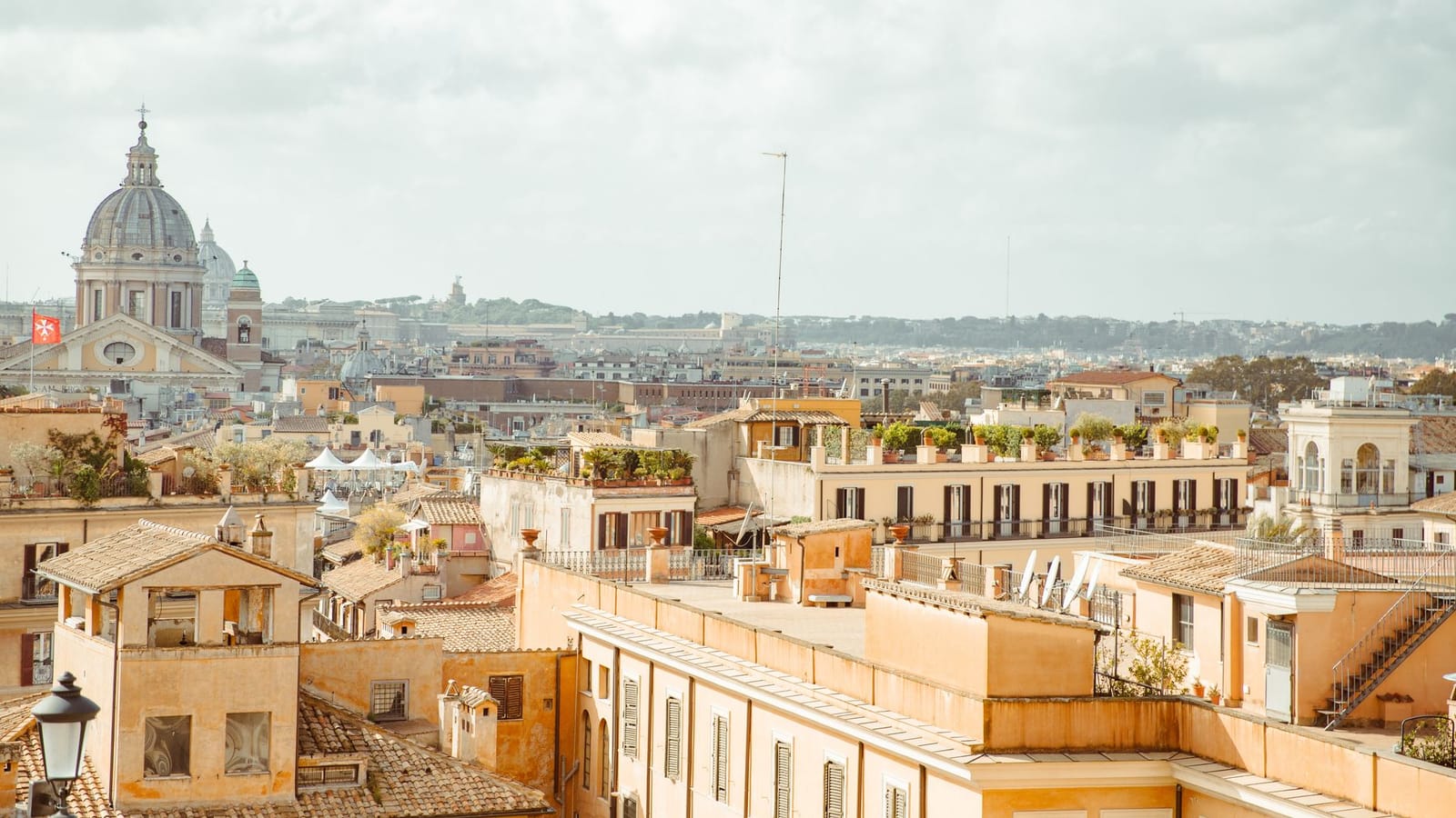 Panoramic view of Rome's historic rooftops highlighting classic Italian architecture and St. Peter's Basilica.