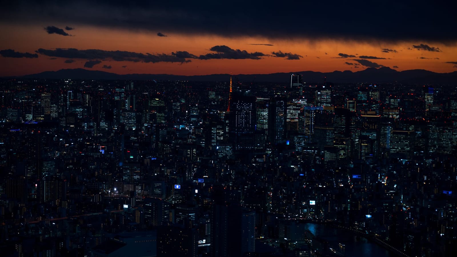 A stunning twilight view of Tokyo's vibrant cityscape featuring iconic landmarks and city lights.