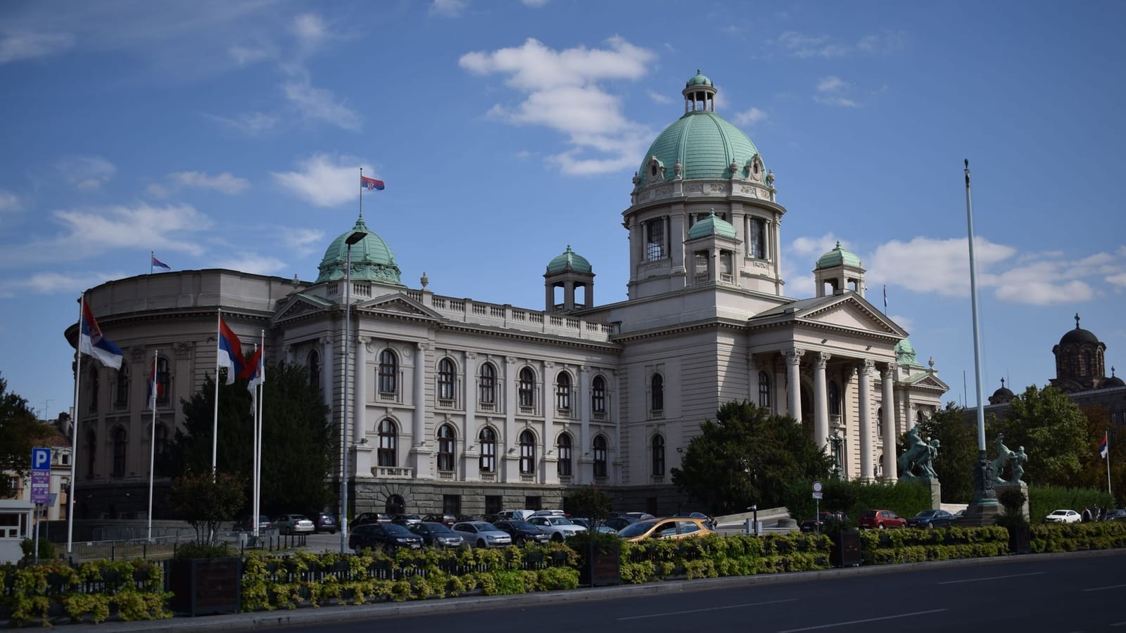 The majestic Serbian National Assembly building in Belgrade, captured on a clear day.