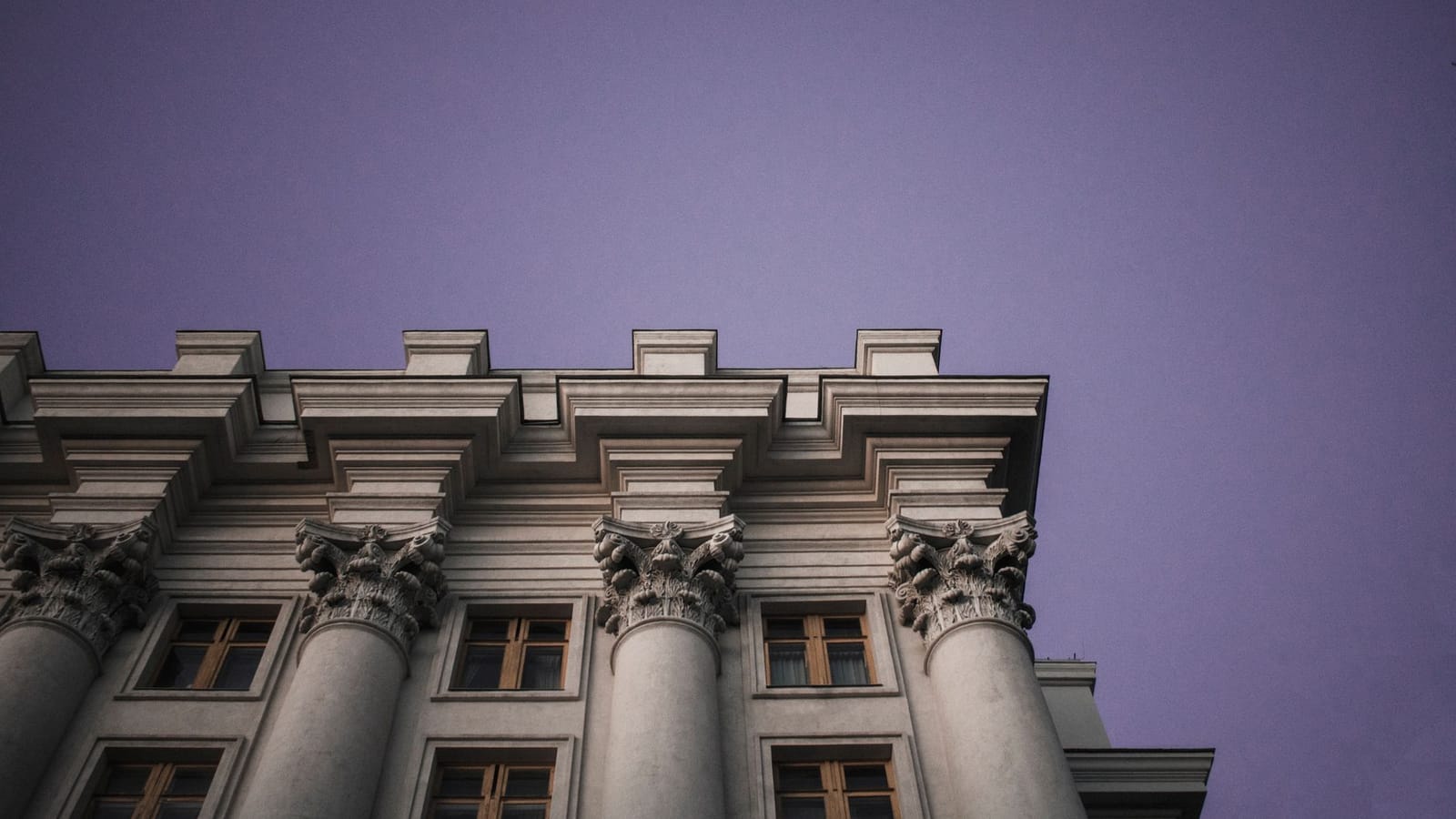Majestic architectural columns against a twilight sky in Kyiv, Ukraine.