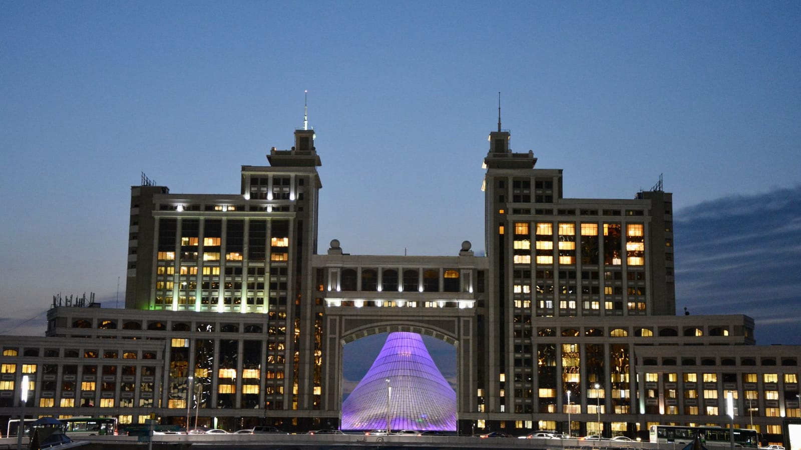 Majestic view of Astana's iconic architecture glowing against evening sky.