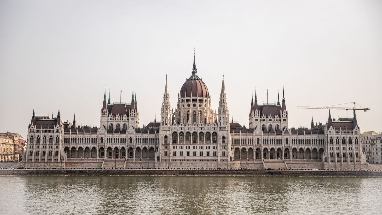 Beautiful capture of the Budapest Parliament Building along the Danube River, showcasing its Gothic Revival architecture.