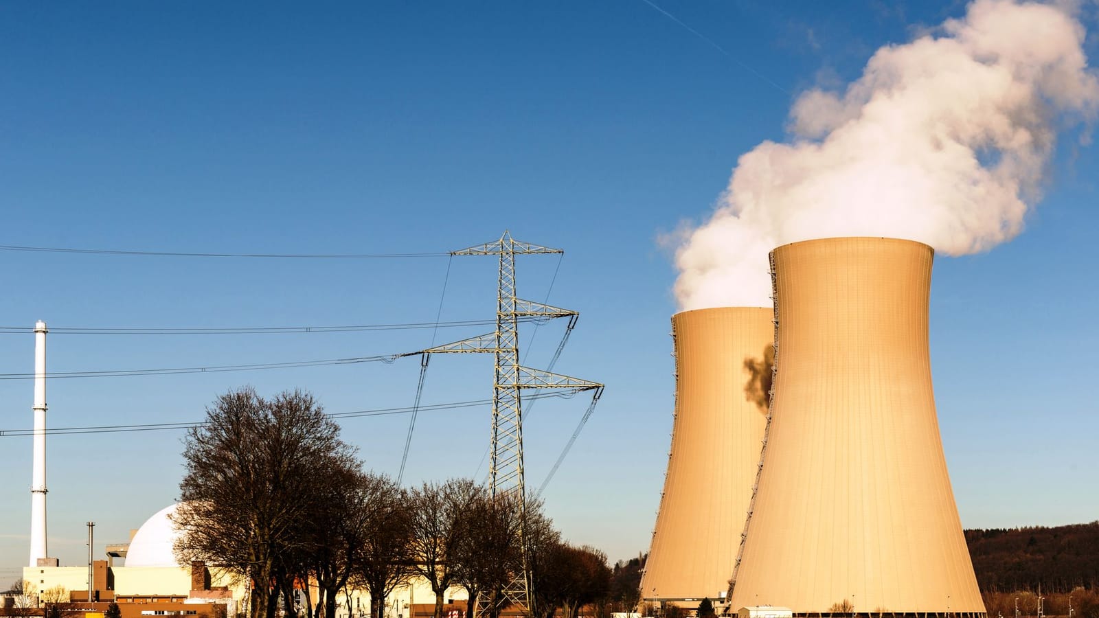 A nuclear power plant in Hameln, Germany, showcasing cooling towers and electricity pylons.