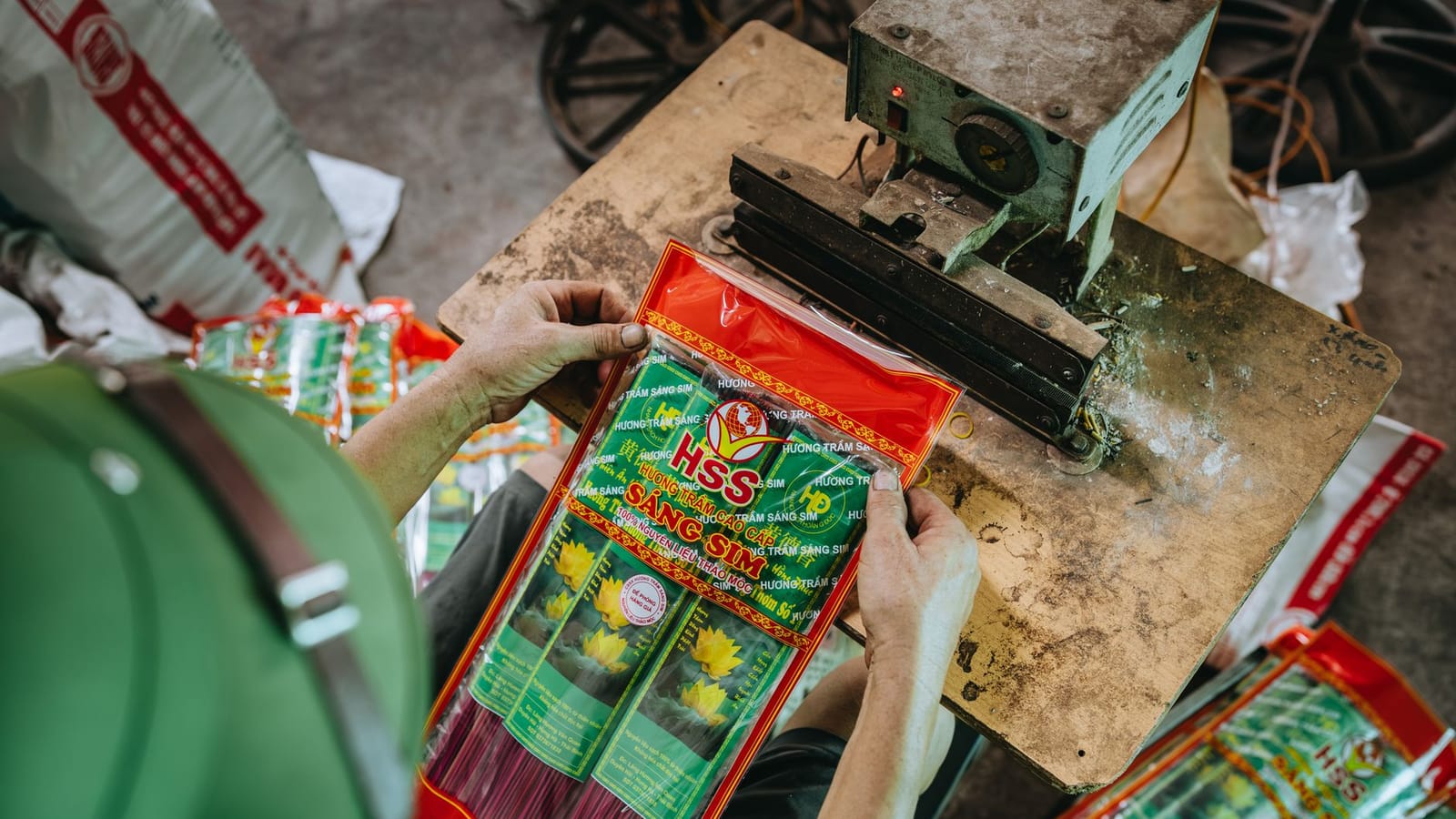 A detailed look at the incense packaging process in a traditional workshop setting.