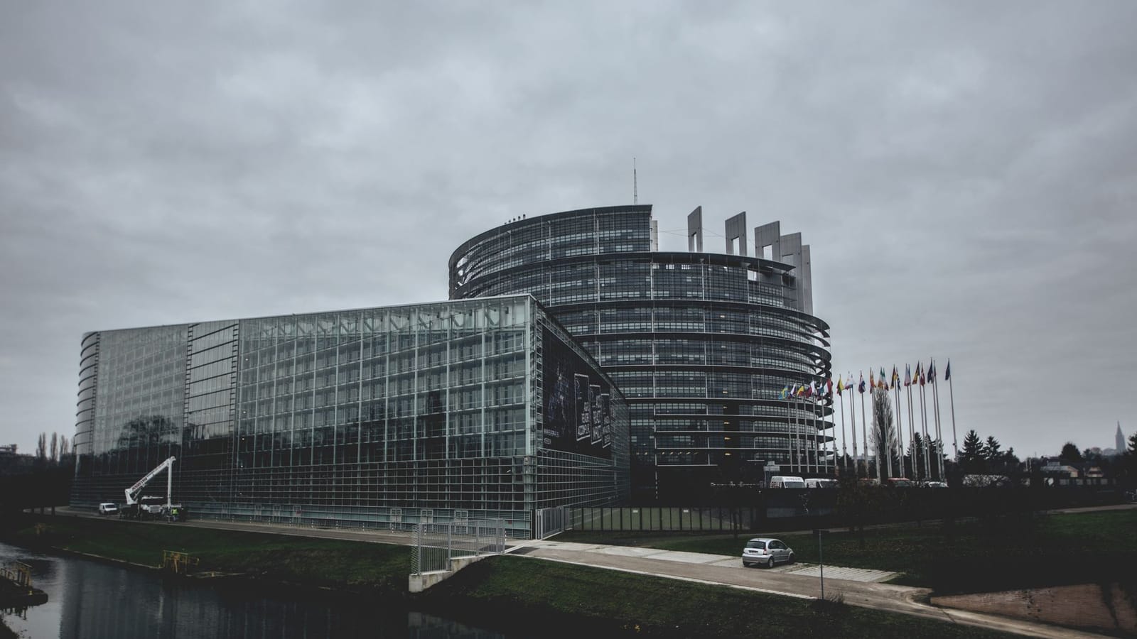 Modern architecture of the European Parliament in Strasbourg on a cloudy day.