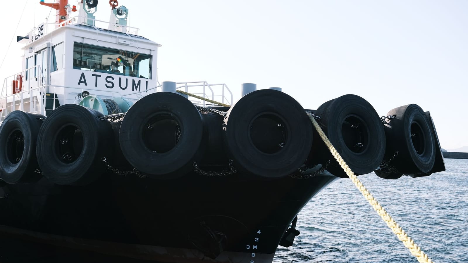 A close-up of tugboat Atsumi moored at Gamagōri Harbor, Japan.