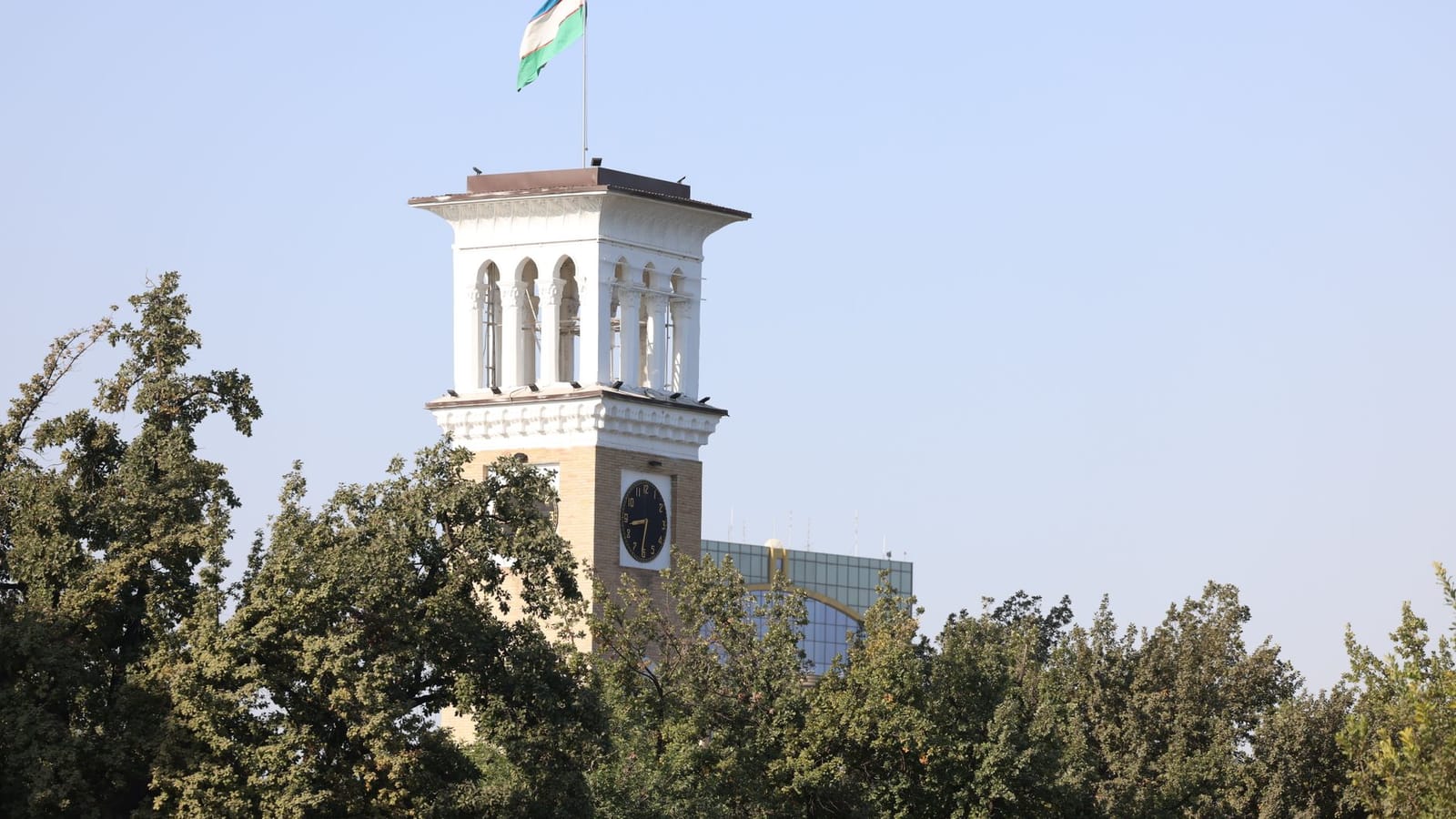 A scenic view of the iconic clock tower in Tashkent, showcasing classic architecture against a clear sky.