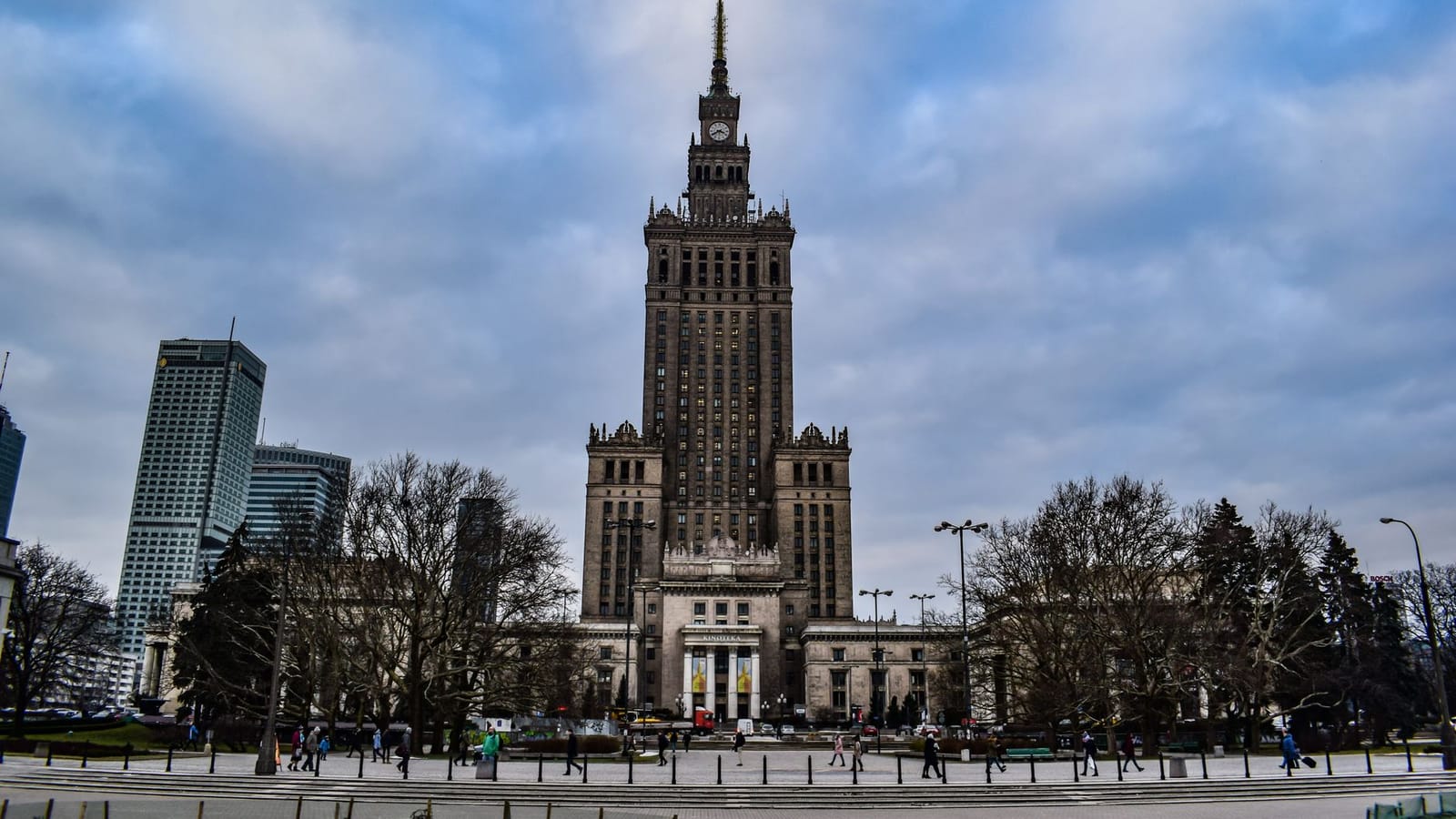 A striking view of Warsaw's Palace of Culture and Science against a cloudy sky.