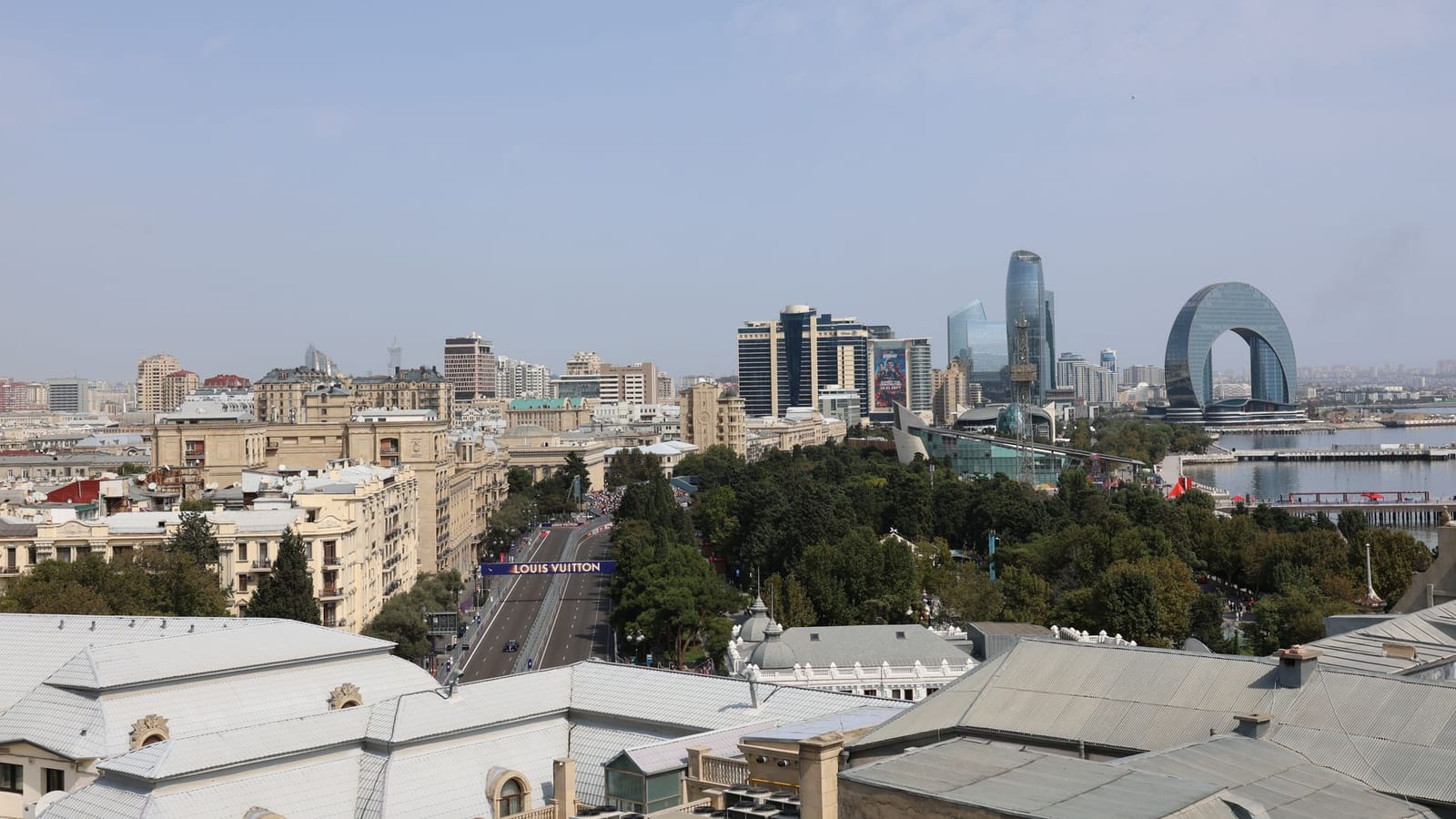 Aerial view of Baku featuring unique modern architecture and buildings against a clear blue sky.
