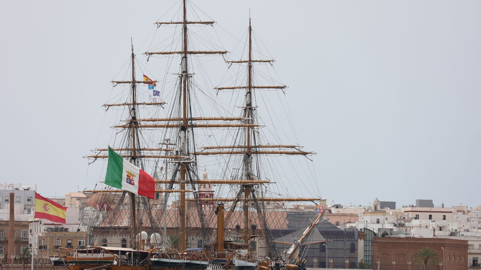 Stunning sailing ship in Cádiz harbor, showcasing naval heritage with flags of Spain and Italy.