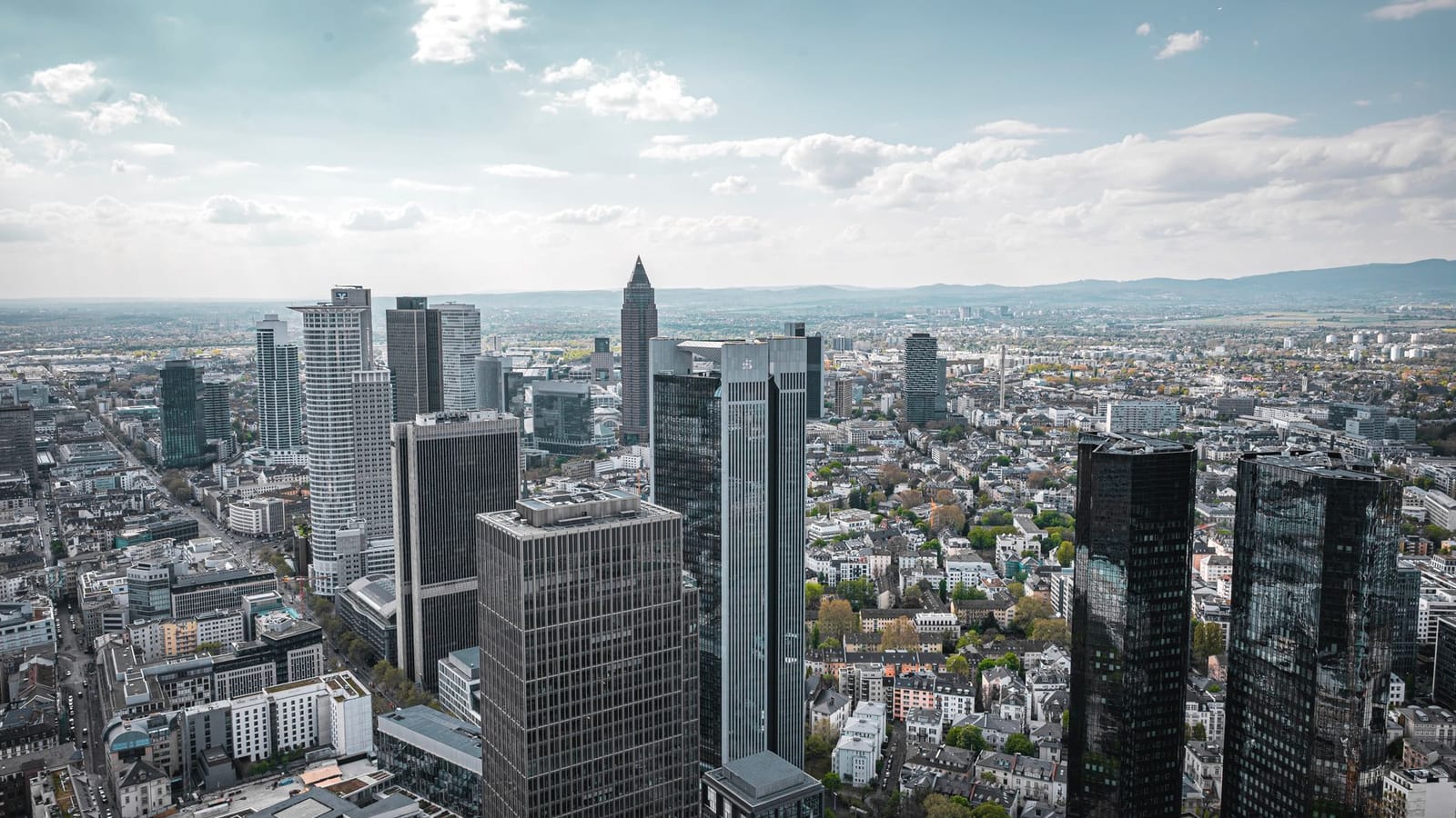 Aerial view of Frankfurt am Main's modern skyline on a clear day.