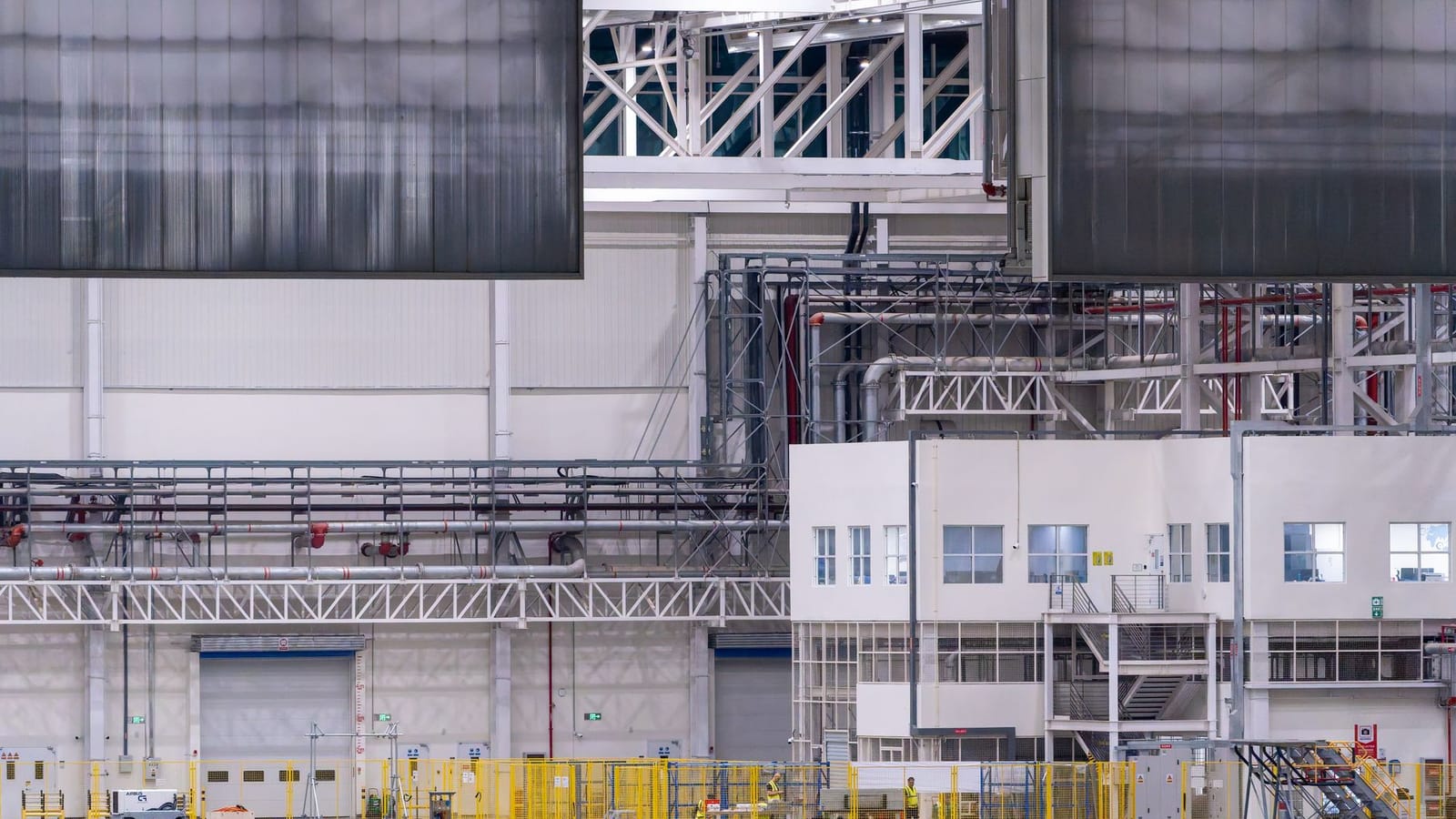Spacious modern factory interior showcasing industrial manufacturing machinery.