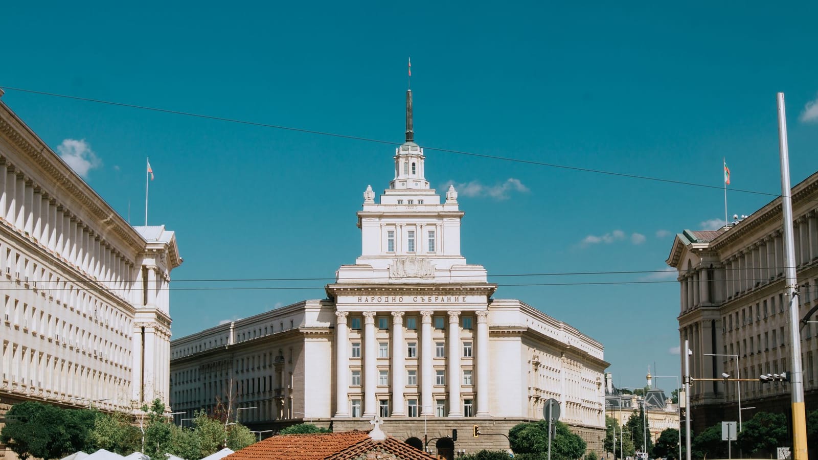 The National Assembly Building in Sofia, Bulgaria under a clear blue sky.
