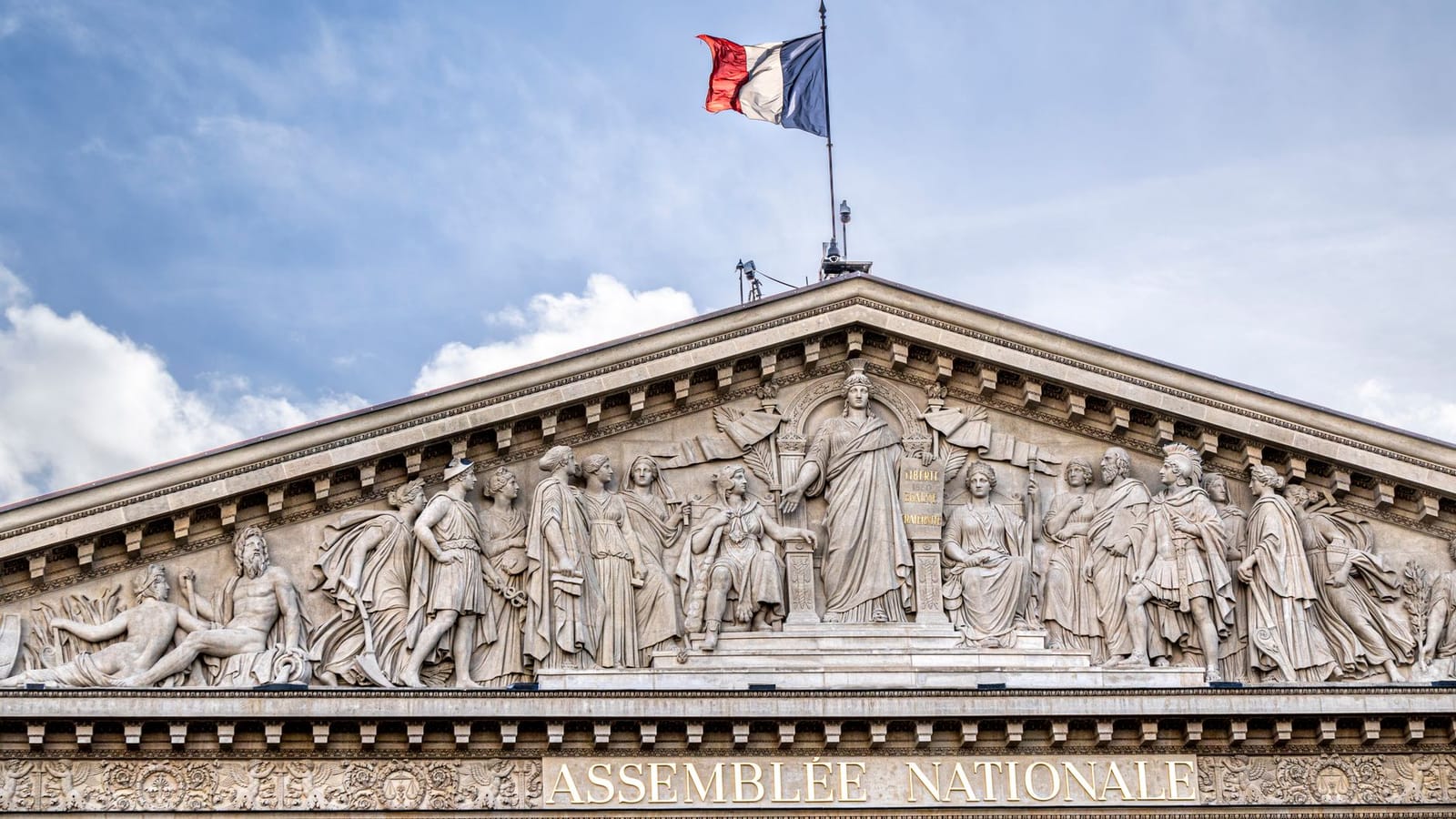 Facade of the French National Assembly building in Paris, showcasing its classical architecture.
