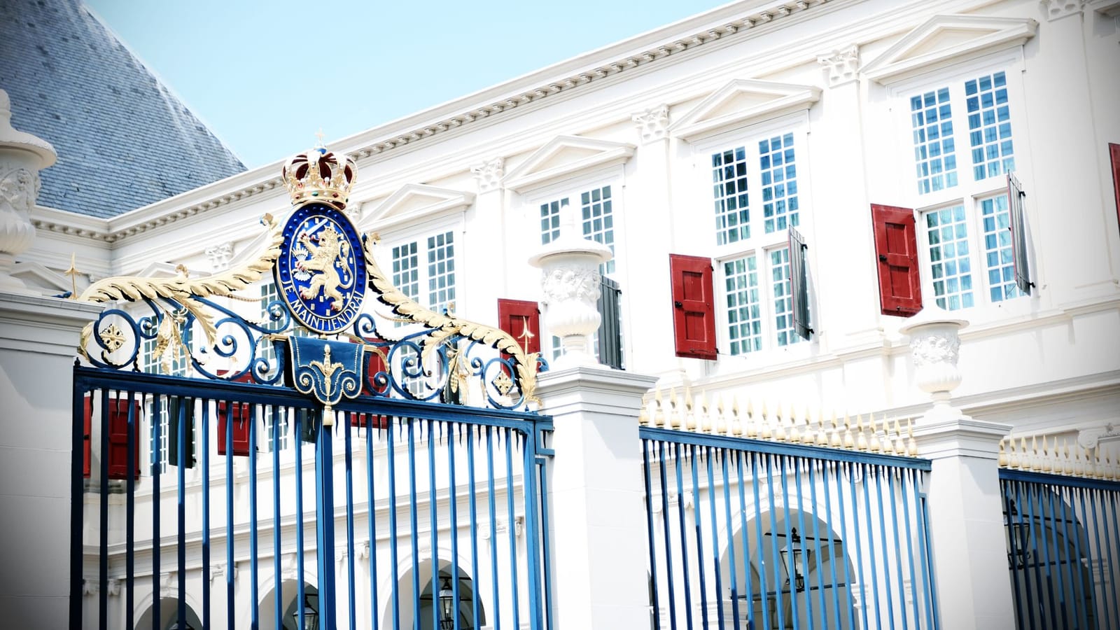 Stunning view of an ornate gate and historical building facade in daylight.