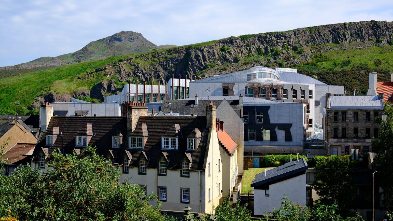 Scenic view of Edinburgh with Arthur's Seat in the background, showcasing historic and modern architecture.