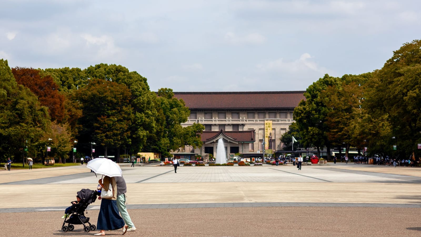 A family walks through Ueno Park in front of the Tokyo National Museum.