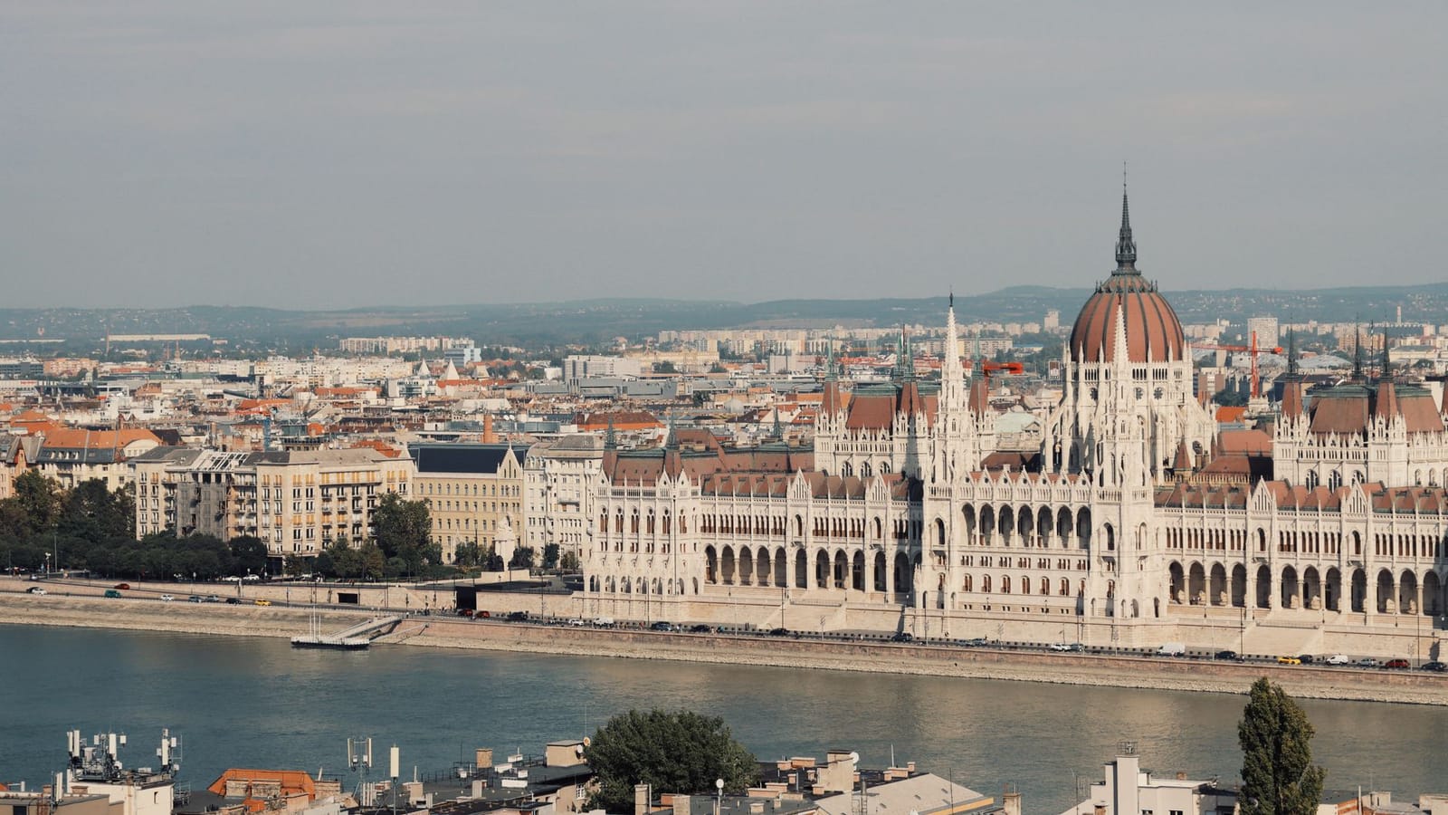 Scenic view of the iconic Hungarian Parliament Building along the Danube River in Budapest.