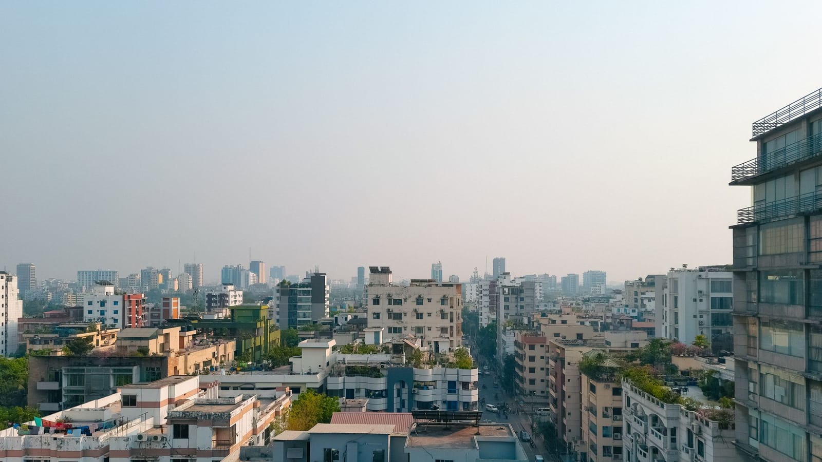 Captivating view of Dhaka's high-rise buildings under a foggy sky, showcasing modern urban architecture.