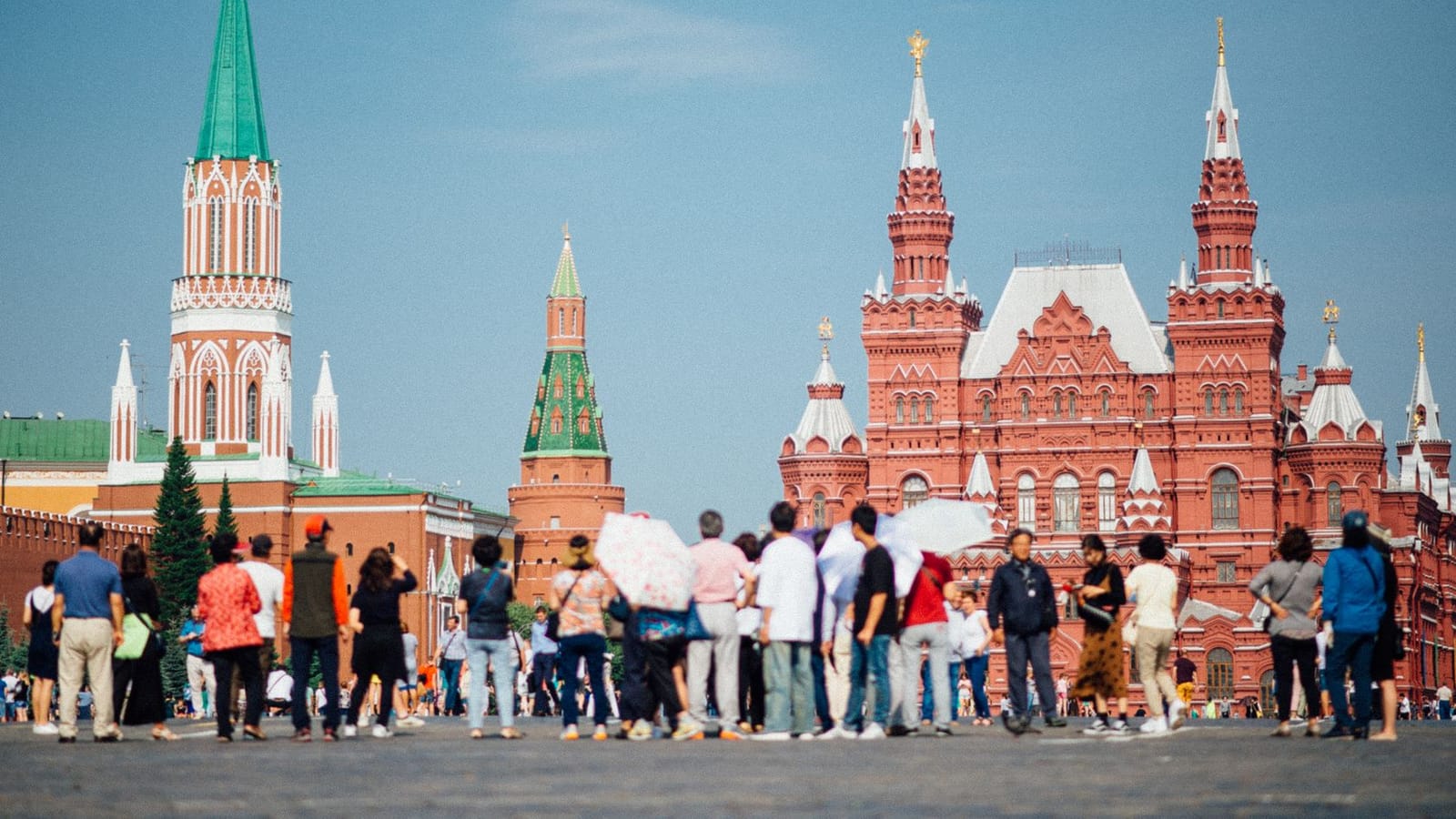 Tourists gathered at Red Square with views of the Kremlin and State Historical Museum in Moscow.