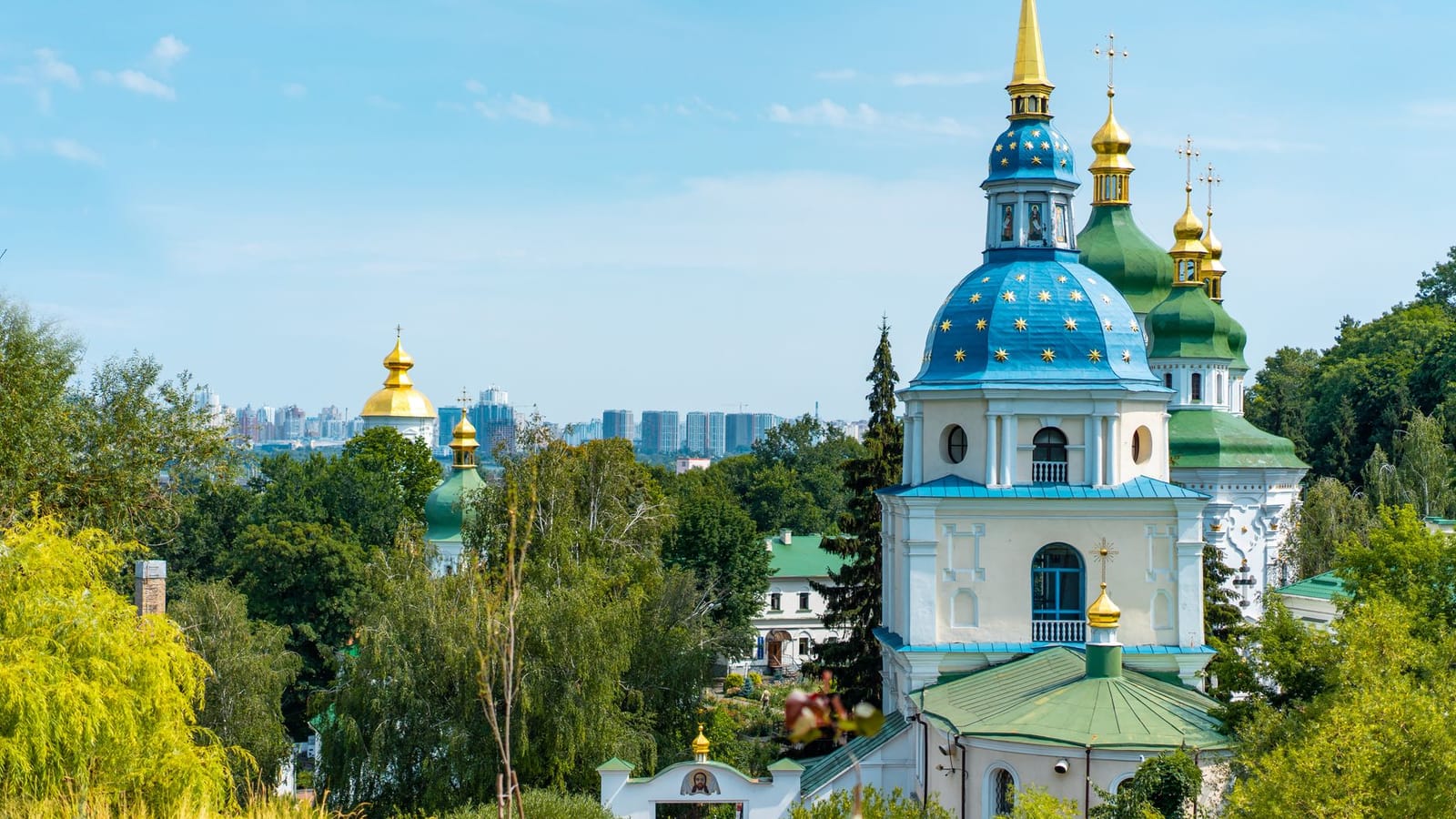 Scenic view of St. Michael's Golden-Domed Monastery in Kyiv, Ukraine with clear blue sky.