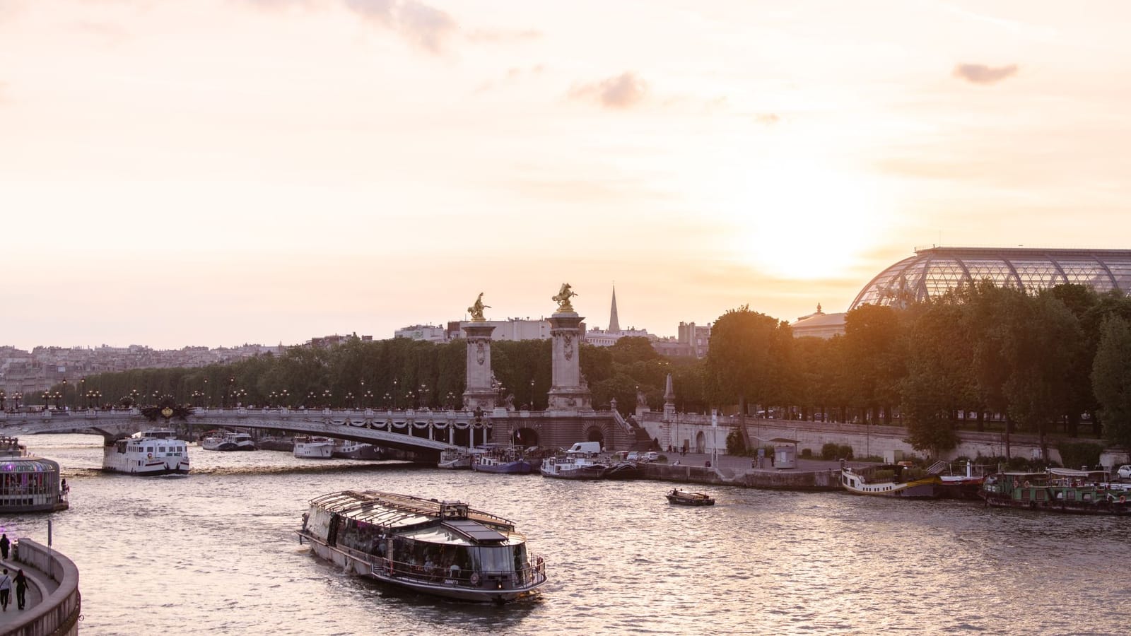 Scenic view of Paris with the Seine River and iconic architecture during sunset.