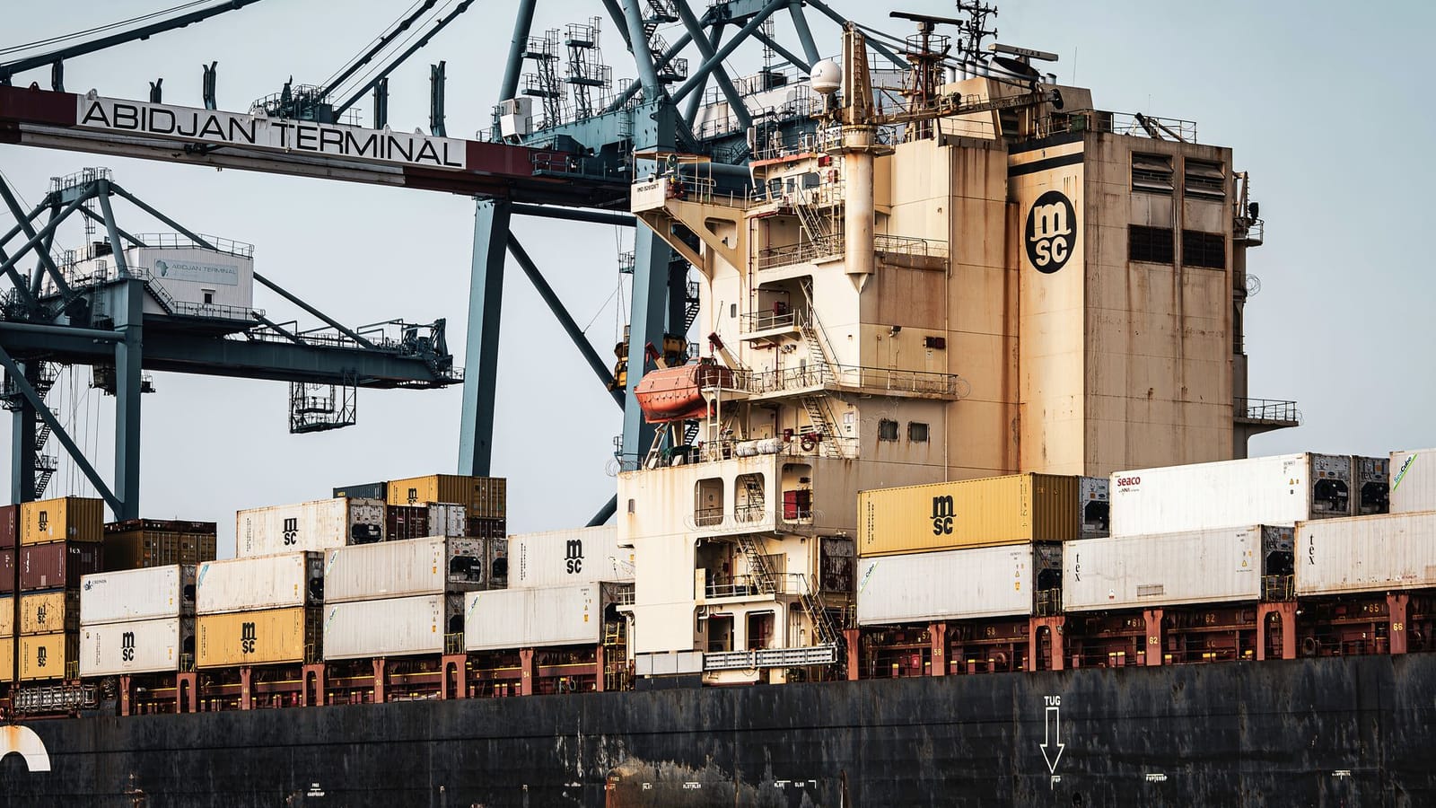 View of shipping containers and cranes at Abidjan Terminal, Ivory Coast.