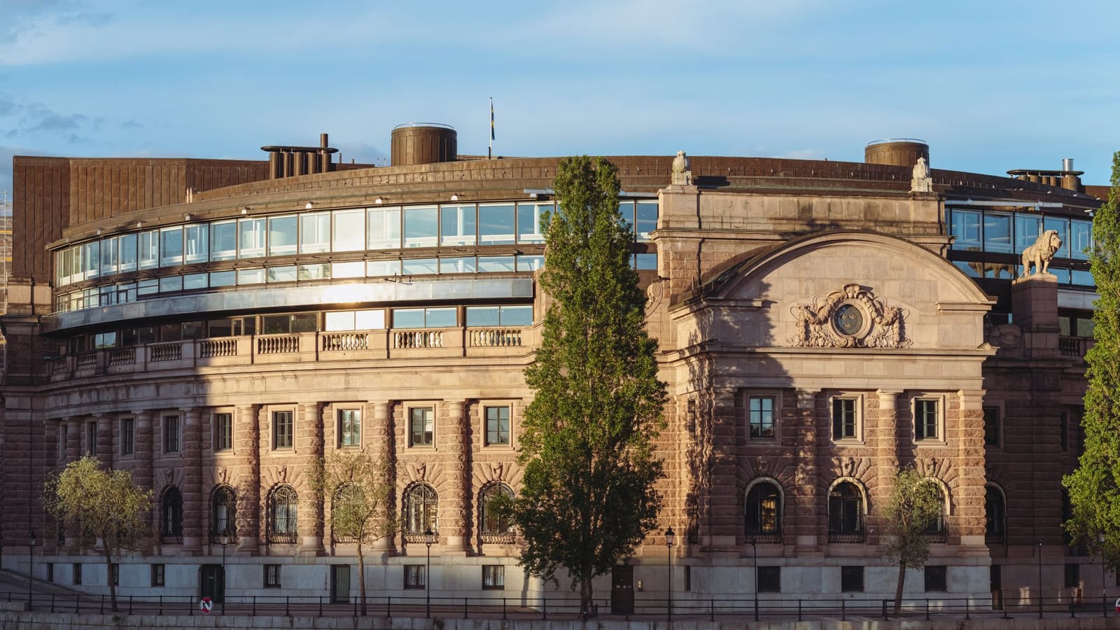 Swedish Parliament House by the waterfront with warm sunset lighting in Stockholm.
