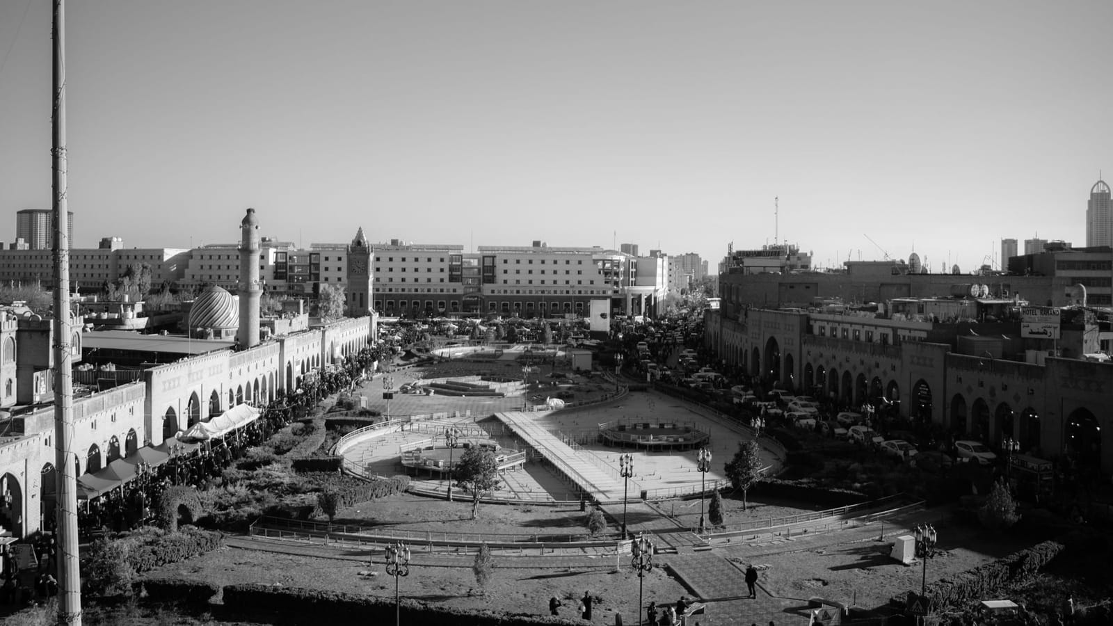 A striking black and white aerial view showcasing Erbil's town square, depicting urban life and architecture in Kurdistan, Iraq.